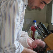 Dad bathing baby